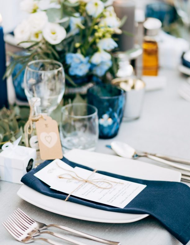 wedding-dinner-table-reception-a-square-plate-with-a-blue-cloth-towel-picture-id1223287180